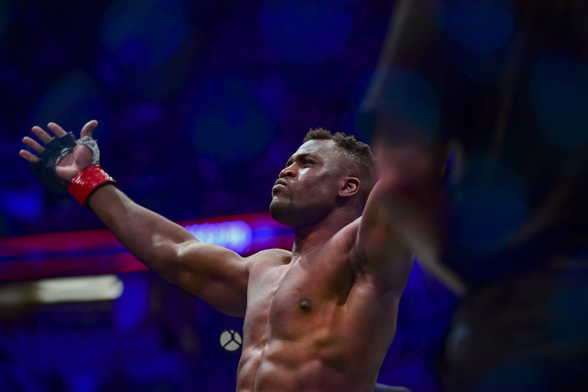 Francis Ngannou raises his arms during UFC fighter announcements.